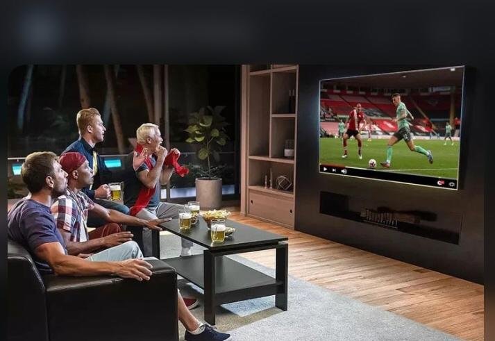 Image of a group of people using an IPTV service to find their favorite channel on a television screen.